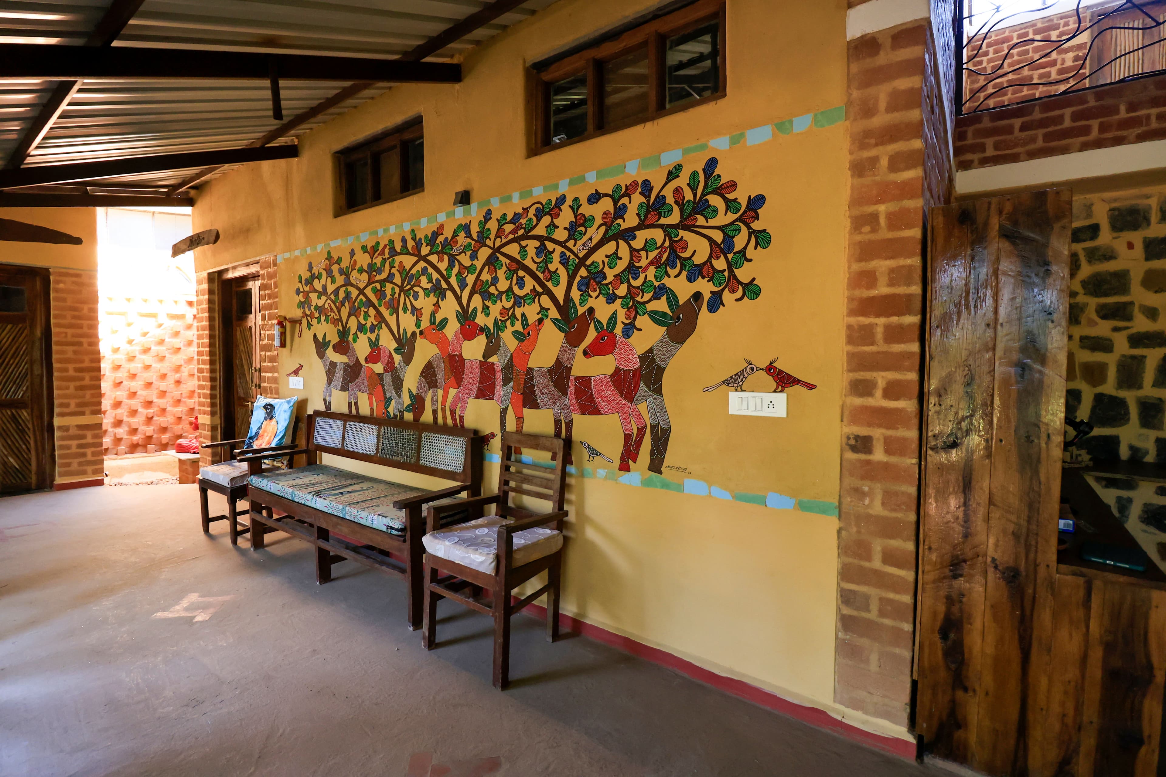A guest learning Gond art from a local artist